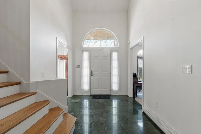 a view of a room with wooden floor and windows