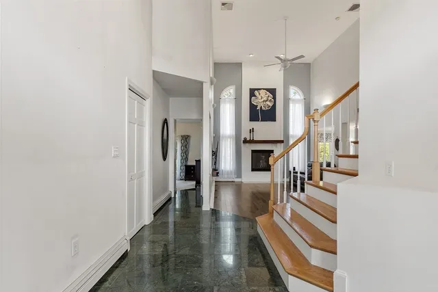 a view of entryway and hall with wooden floor