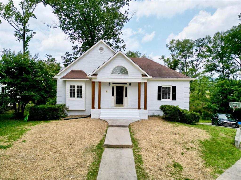 a front view of a house with yard and green space