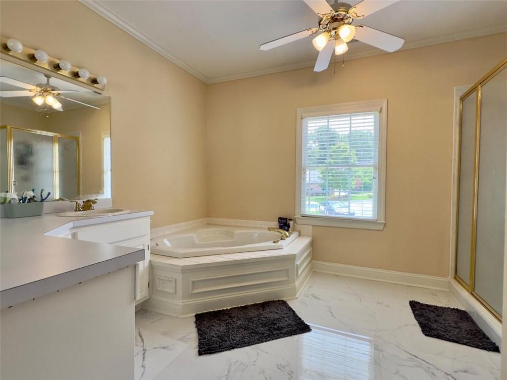 11 Stonegable Drive Northwest Rome, GA 30165 - Photo 18 of 32 a bathroom with a sink a mirror and a bathtub