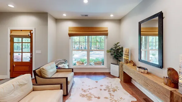 a living room with fireplace furniture and a wooden floor