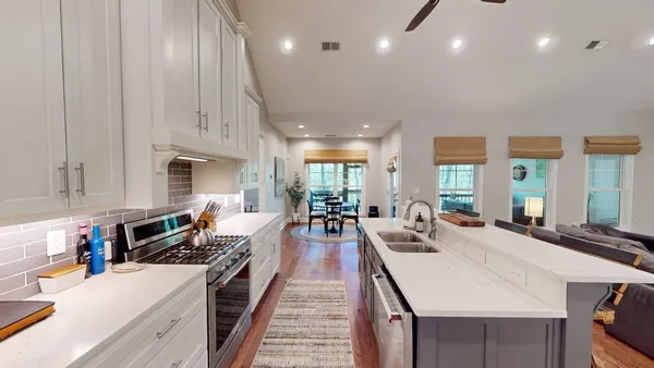 a kitchen with stainless steel appliances a sink and a large mirror