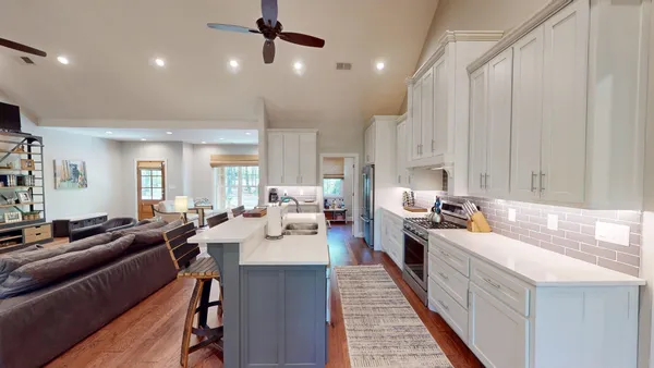 a kitchen with a sink cabinets and wooden floor