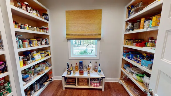 a bedroom with furniture and wooden floor
