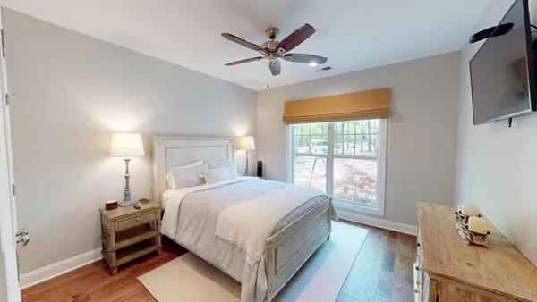 a bedroom with a bed and a ceiling fan