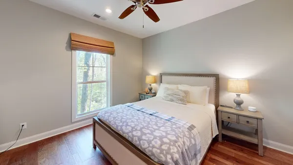 a bedroom with a bed and a lamp