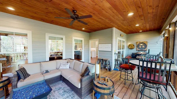 a living room with furniture a ceiling fan and a rug