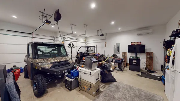 a view of a porch with chairs and potted plants