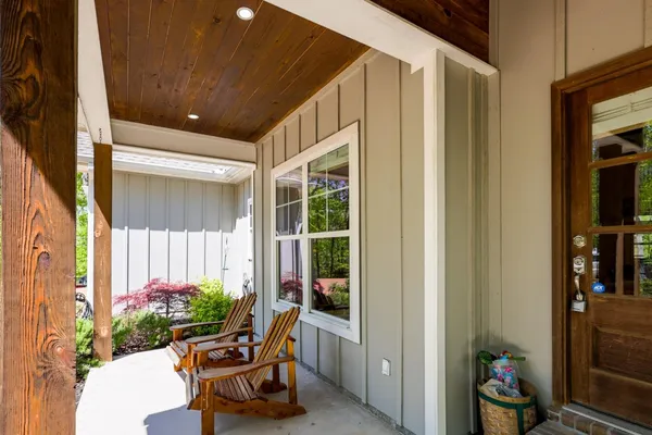 a front view of a house with a garden and yard