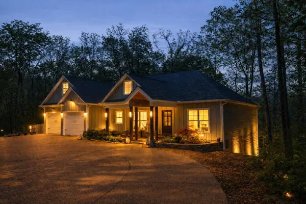 a living room with furniture kitchen view and a wooden floor