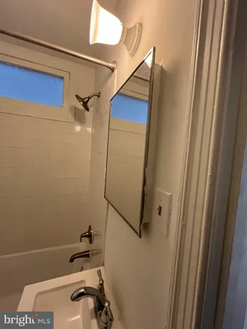 a bathroom with a shower and a sink