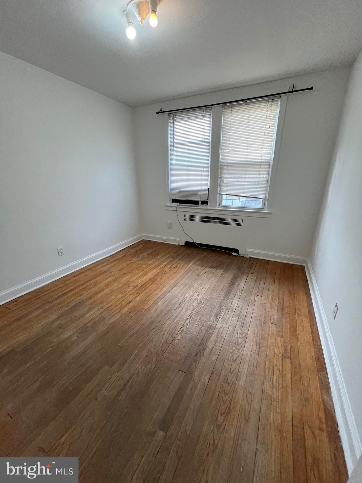 4034 7th Street Northeast, Unit 2 Washington, DC 20017 - Photo 6 of 9 wooden floor in an empty room with a window
