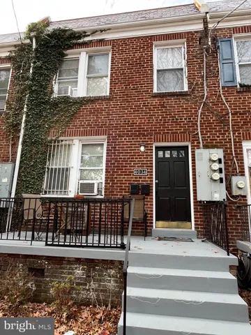 a view of a brick house with many windows