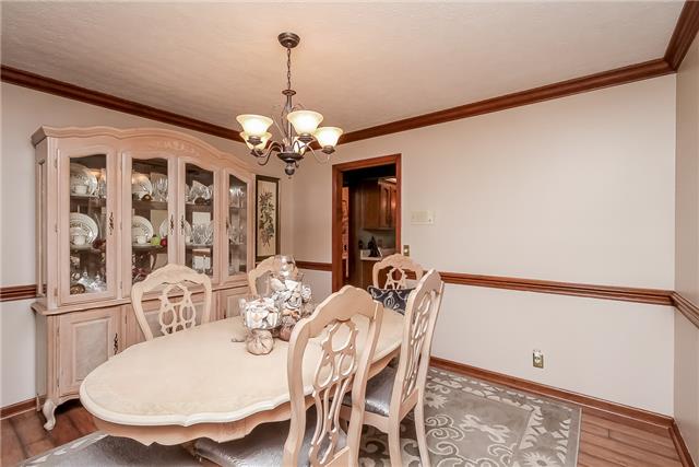 The dining room is directly off the kitchen and can fit a large table, chairs, and china cabinets!  Neutral colors brighten it up along with a couple of windows too.