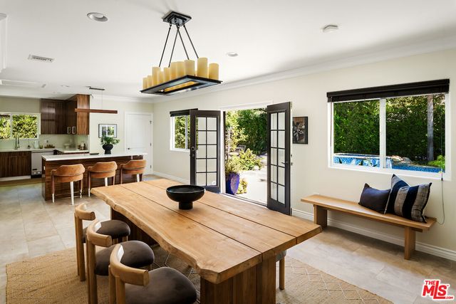 a living room with furniture a rug and a chandelier