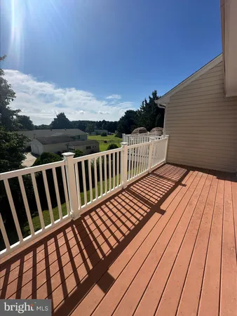 a view of balcony with wooden floor and fence