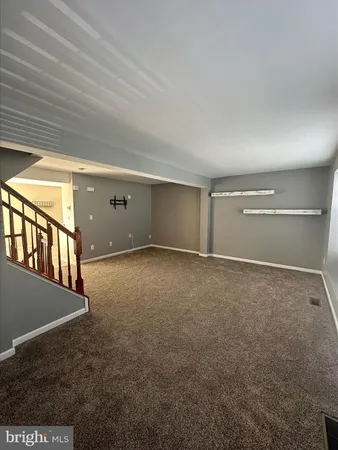 a view of an empty room with windows