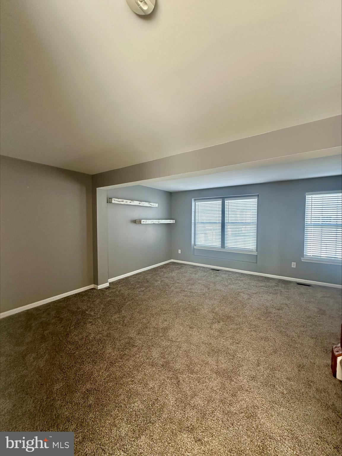 23567 Devonshire Road Millsboro, DE 19966 - Photo 13 of 25 an empty room with a empty space and windows