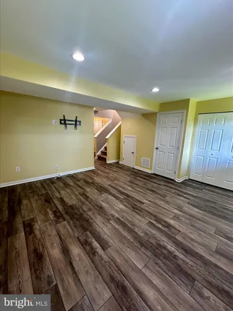 a view of a room with wooden floor