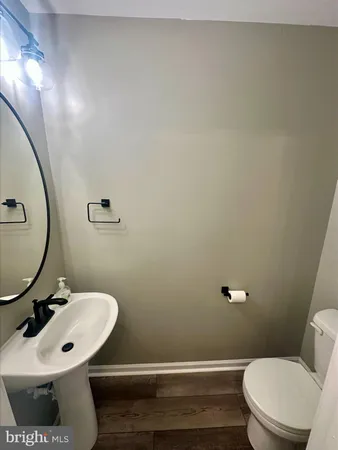 a bathroom with a sink a toilet and mirror