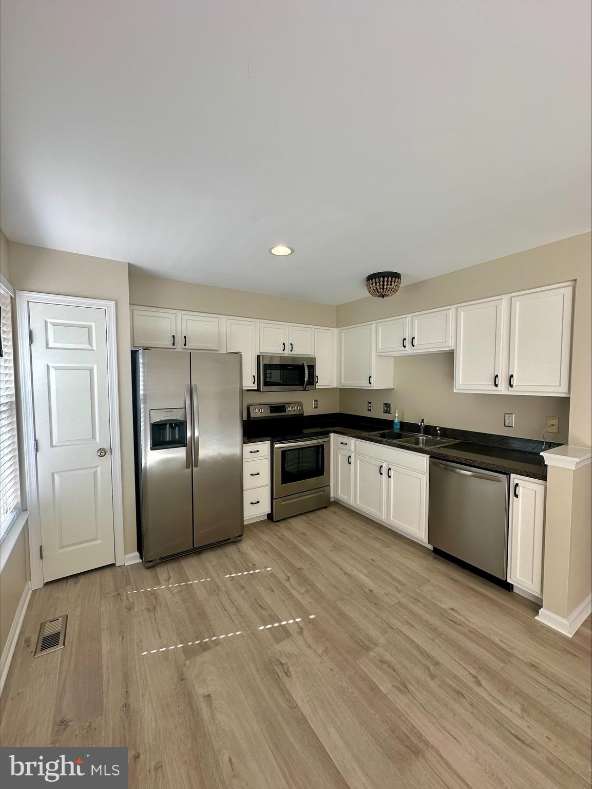 23567 Devonshire Road Millsboro, DE 19966 - Photo 8 of 25 a large kitchen with cabinets and stainless steel appliances