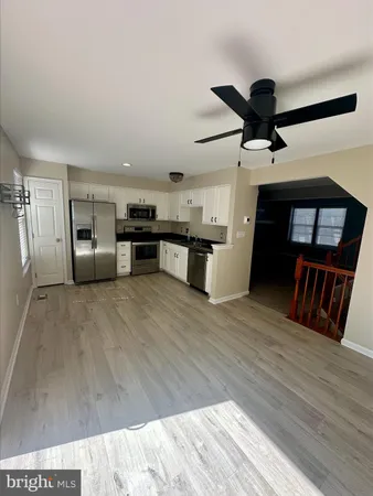 a view of a kitchen with a sink cabinets and wooden floor