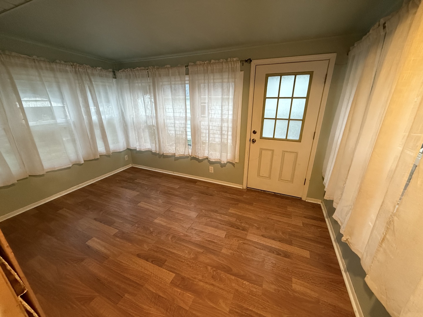 404 Thoria Road Batavia, IL 60510 - Photo 3 of 15 an empty room with wooden floor and windows