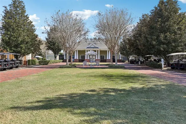 a front view of a building with trees around