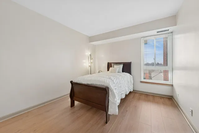 a bedroom with a bed and window