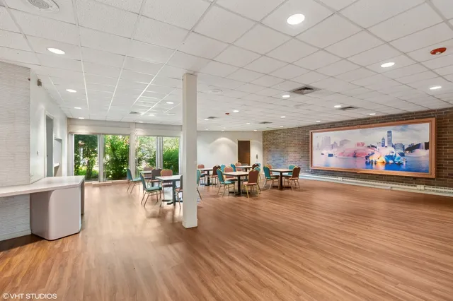 a view of a room with furniture large window and wooden floor