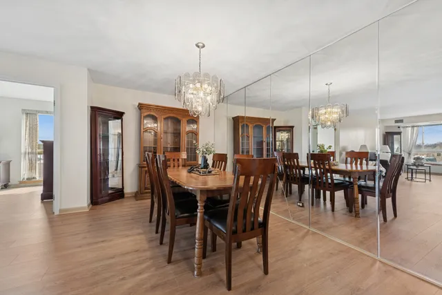 a view of a dining room with furniture and chandelier