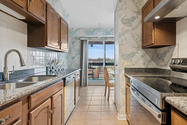 a kitchen with granite countertop a sink and cabinets