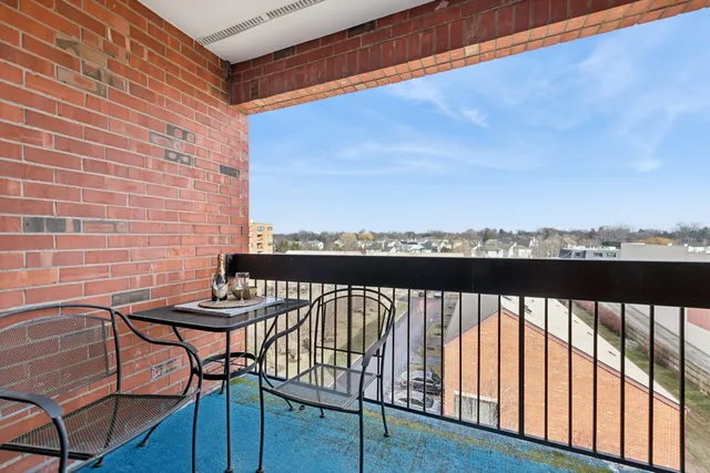 a view of a balcony with furniture and wooden floor