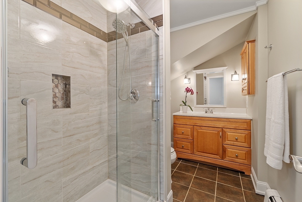 73 Forest Road Millis, MA 02054 - Photo 18 of 34 a bathroom with a shower sink and mirror