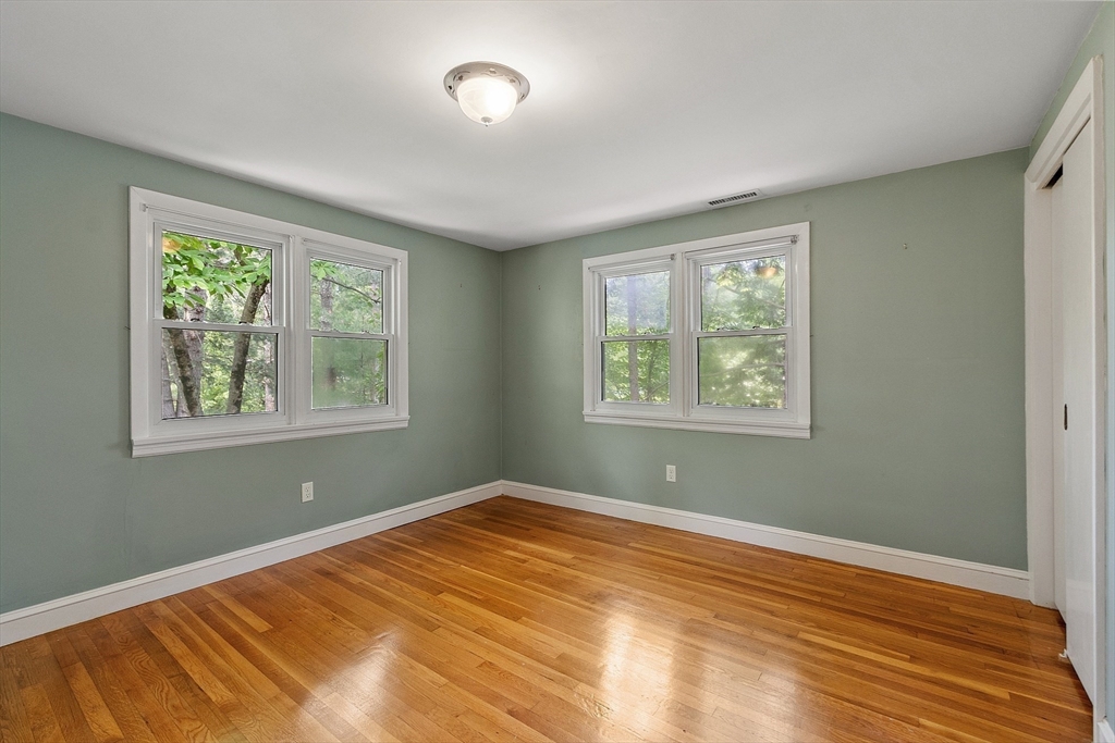 73 Forest Road Millis, MA 02054 - Photo 23 of 34 a view of an empty room with wooden floor and a window