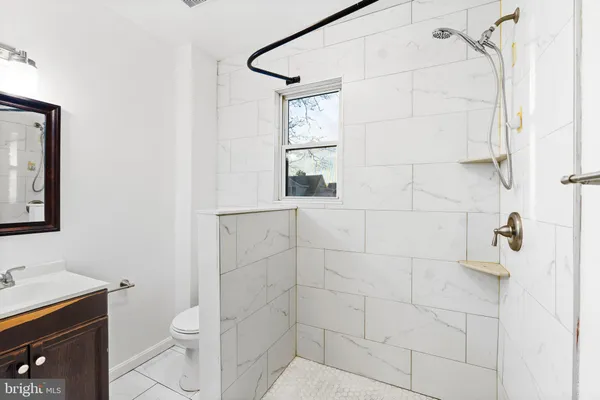 a bathroom with a toilet sink and shower