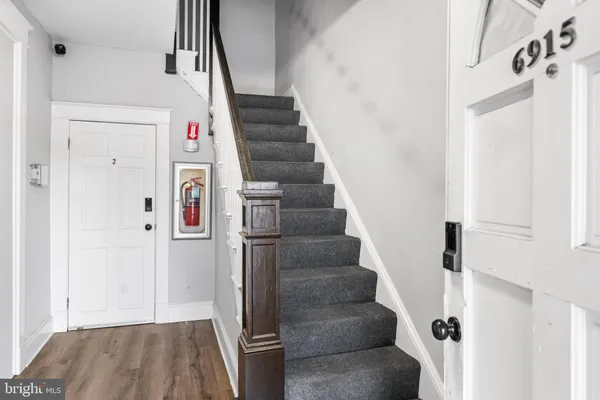 a view of entryway and hall with wooden floor