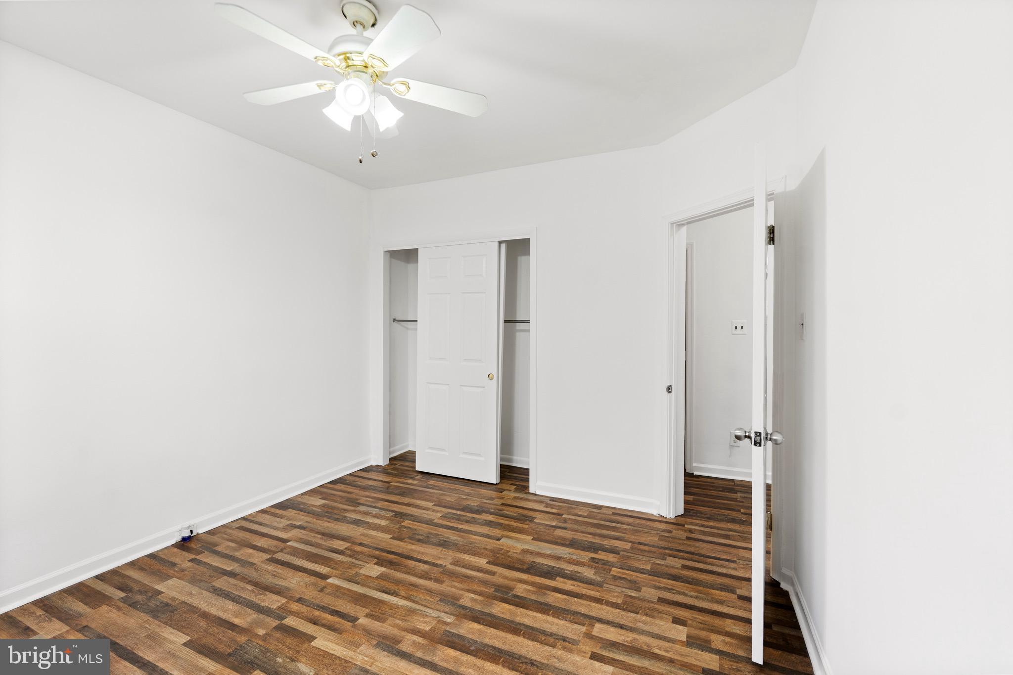 6915 Harford Road, Unit 3 Baltimore, MD 21234 - Photo 2 of 16 a view of a room with wooden floor and a ceiling fan