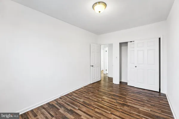 a view of a room with wooden floor and white walls