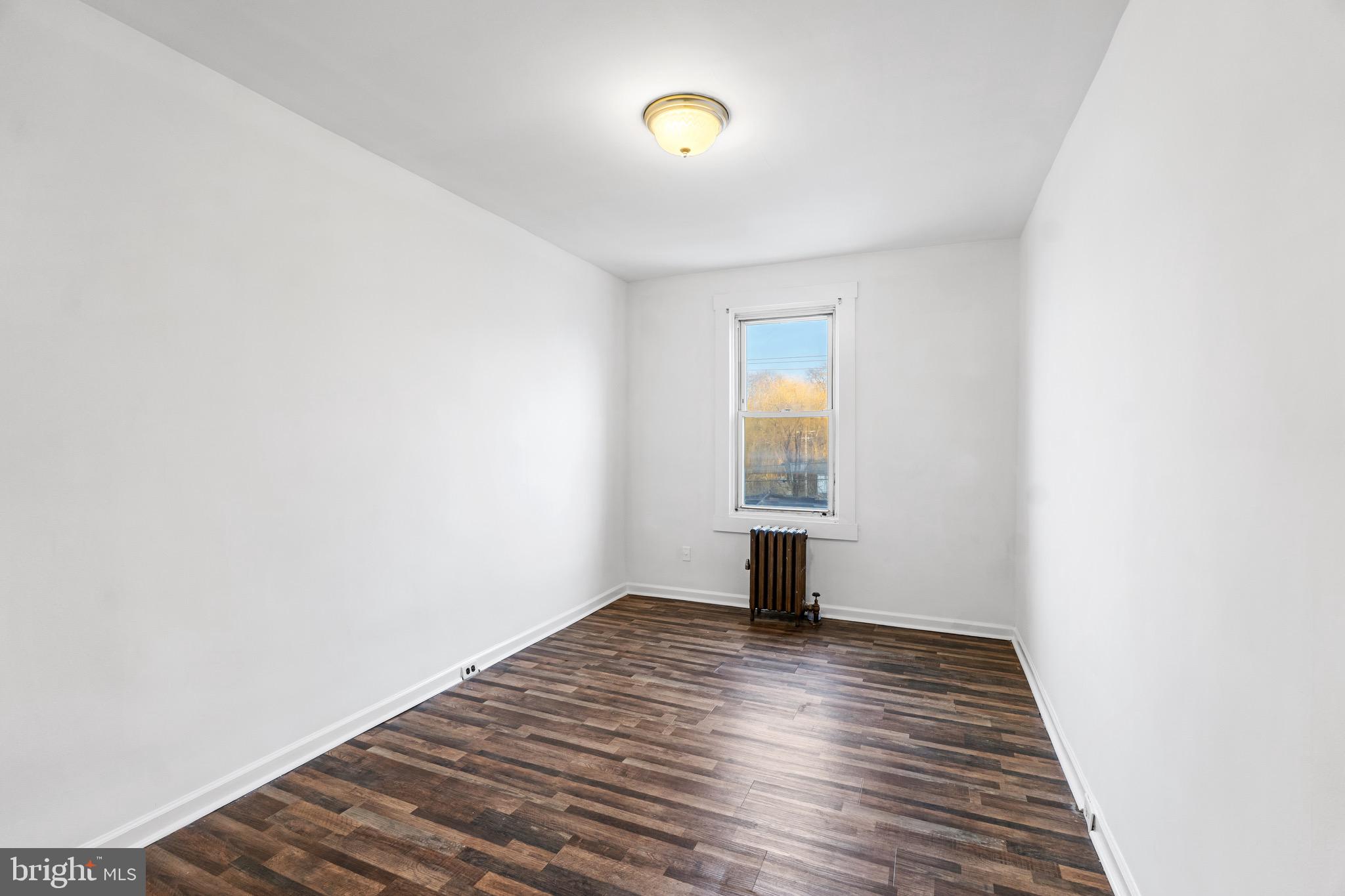 6915 Harford Road, Unit 3 Baltimore, MD 21234 - Photo 7 of 16 a view of empty room with wooden floor