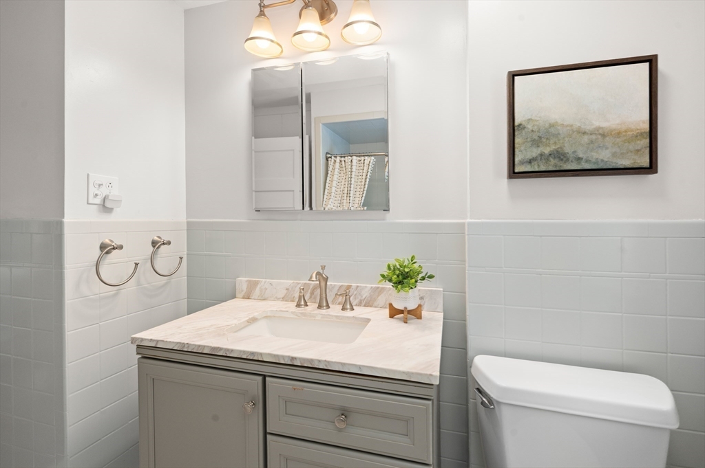 8 Overlook Road Wakefield, MA 01880 - Photo 34 of 41 a bathroom with a toilet sink and mirror