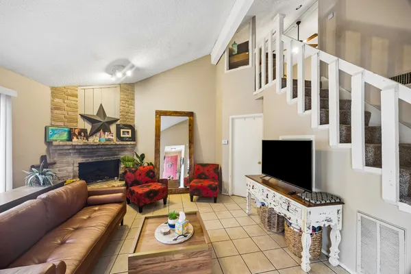 a living room with furniture fireplace and flat screen tv