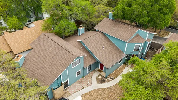 an aerial view of a house with yard