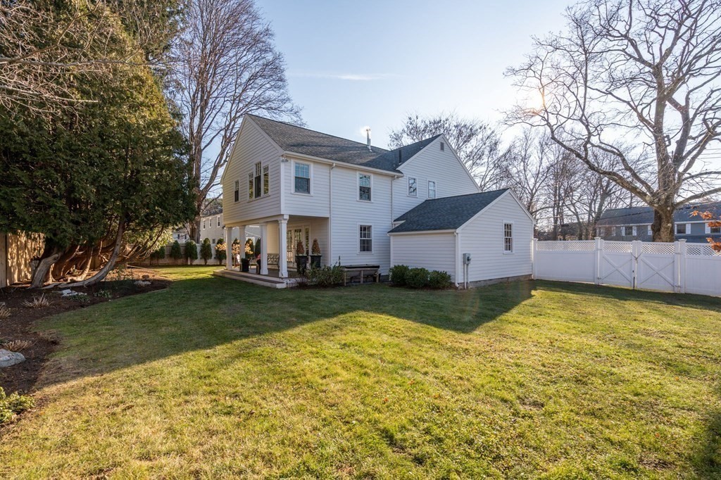 89 Beechwood Road Wellesley, MA 02482 - Photo 20 of 32 a view of a white house next to a yard with a large tree