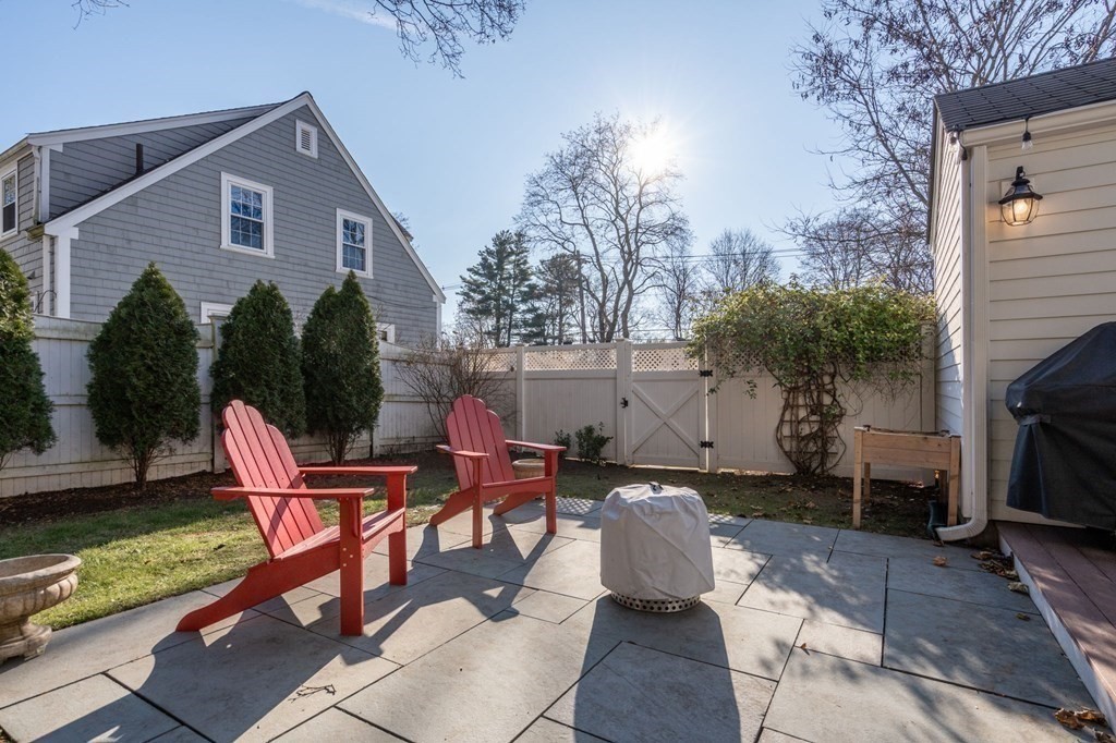 89 Beechwood Road Wellesley, MA 02482 - Photo 22 of 32 a view of a chairs and table in backyard of the house