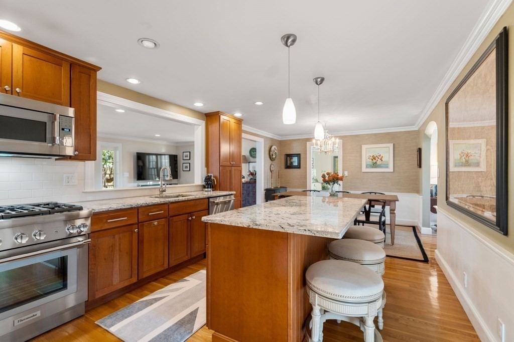 89 Beechwood Road Wellesley, MA 02482 - Photo 3 of 32 a large kitchen with sink a stove and chairs