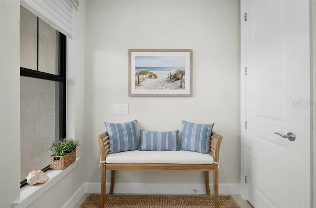 a view of an empty room with glass door and windows
