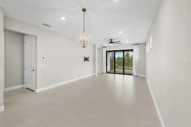 a bedroom with a bed and a potted plant on dresser