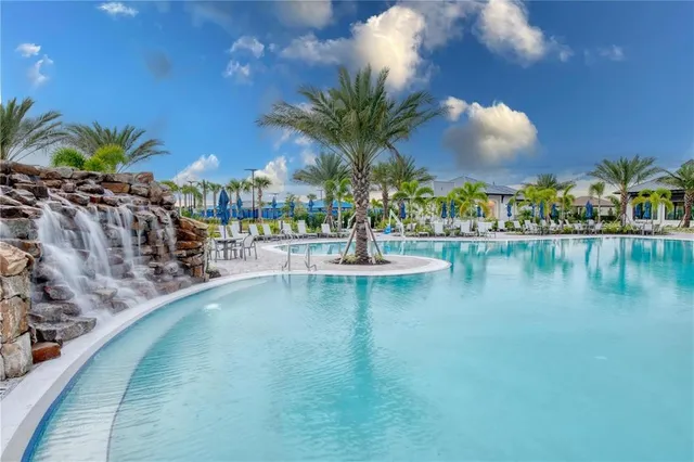 a living room with patio furniture and a potted plant
