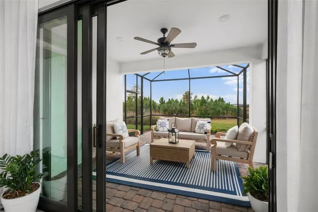 a kitchen with white cabinets and a stove with wooden floor